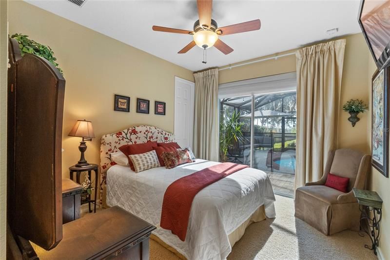 Guest bedroom looking out to the pool and lake.