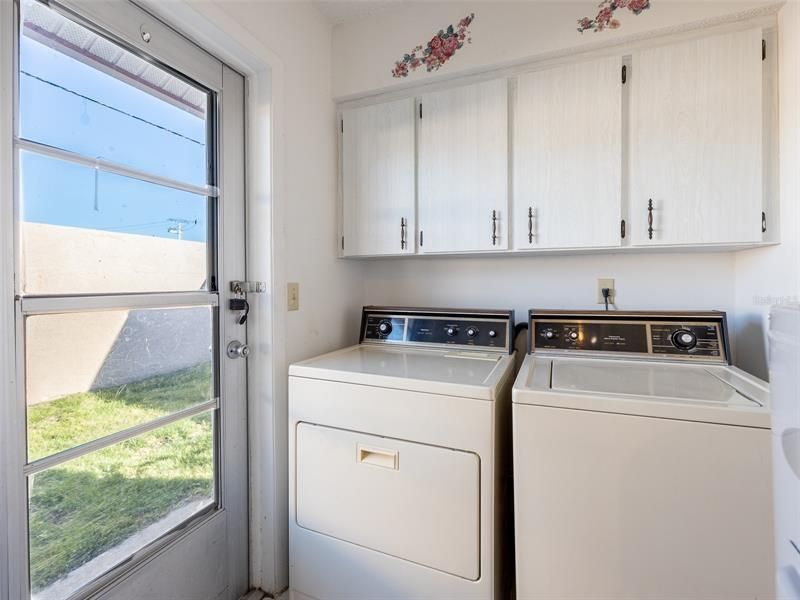 Laundry room adjacent to the kitchen with a door to the back yard! Storage!!