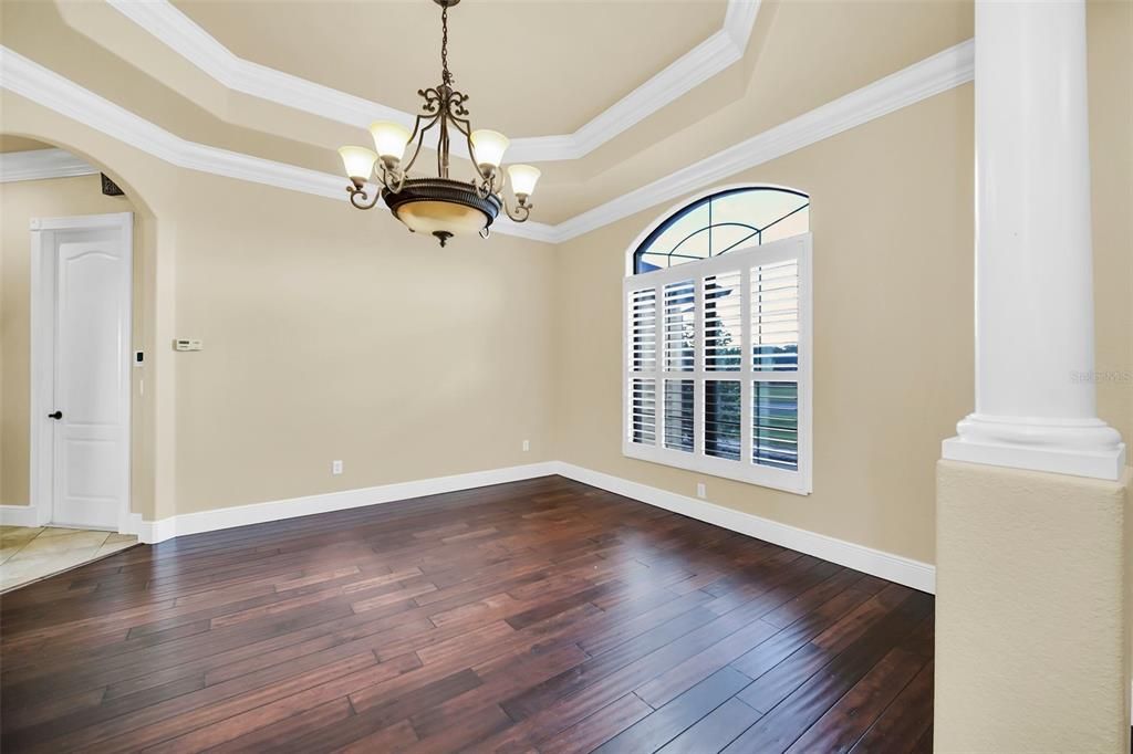 Dining Room with tray ceiling and crown molding