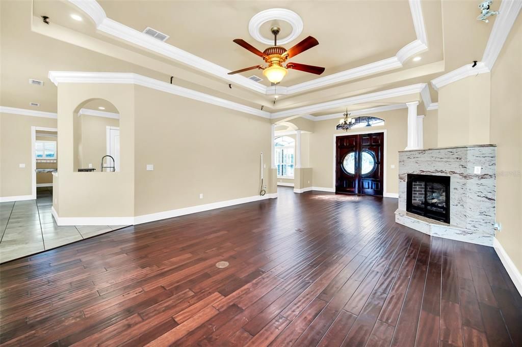 Custom built with open floorplan featuring Double wood door entrygas fireplace, electronic connections, tray ceilings, hardwood floors,