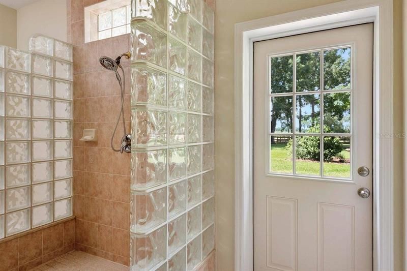 Walk-through Shower in Master Bathroom. Door leads to backyard and outdoor shower area.