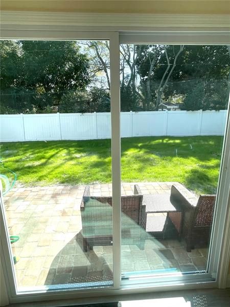 Double pane, impact rated glass sliders take you to your paver deck overlooking the private back yard.