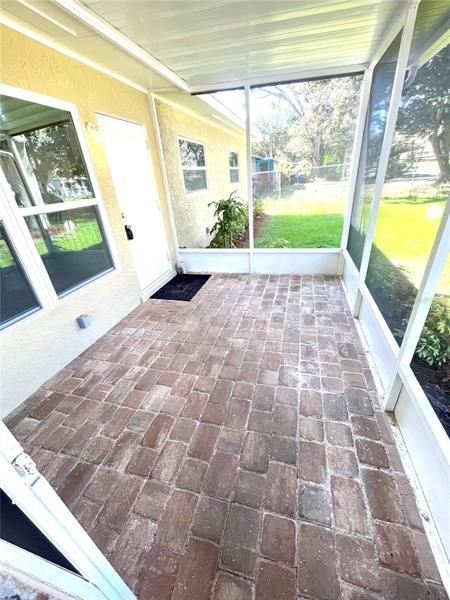 Screened front porch with beautiful paver bricks
