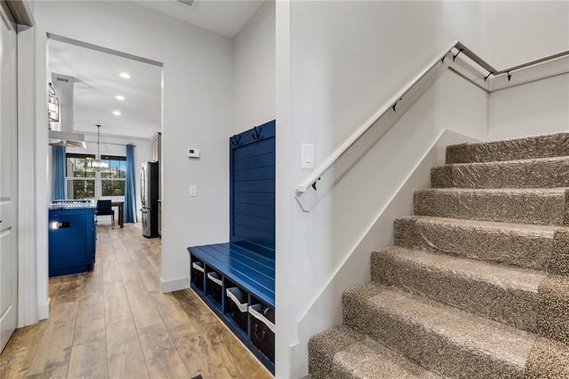 View from garage of stairs to bonus room , mud area , kitchen , and laundry