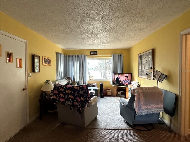 Living Room With Large Windows Viewing Lake