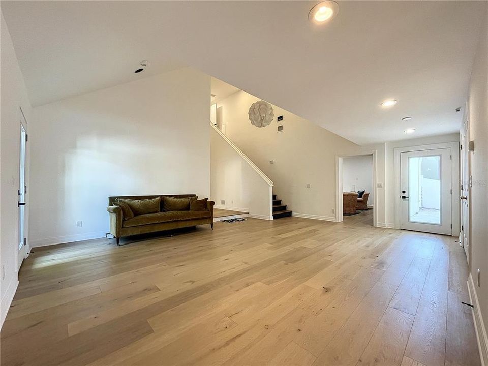 The new addition, a sitting room, leads up to the mother in law suite, and media room.  Right door could be a new entrance if so this would make a grand foyer.  The right door leads to the side courtyard.