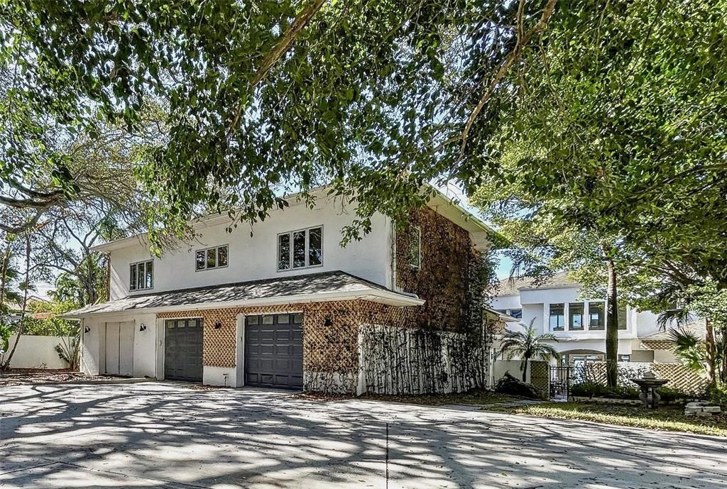 The front of the home from from the driveway view, goes along the pathway and through the courtyard and to the front door.  A separate doorway exists that could become a new or separate entrance with some minor changes in landscaping.