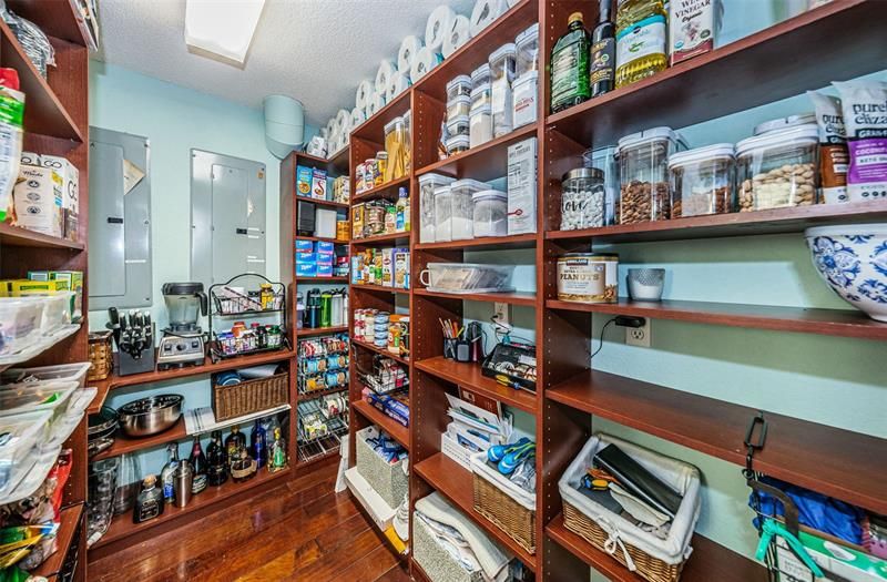 Expansive wood shelved pantry for all of your storage needs.