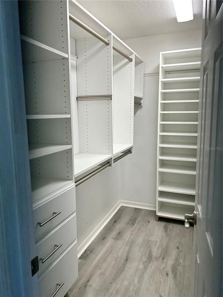 Master walk-in closet with built ins on all sides