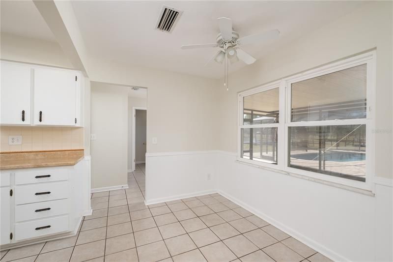 Breakfast nook and door to Laundry, Pool Bath, Garage, and Screened Porch