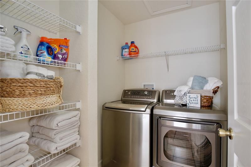 2nd floor laundry room that comes with the washer & dryer and built in shelving perfect for all your linens and storage needs.