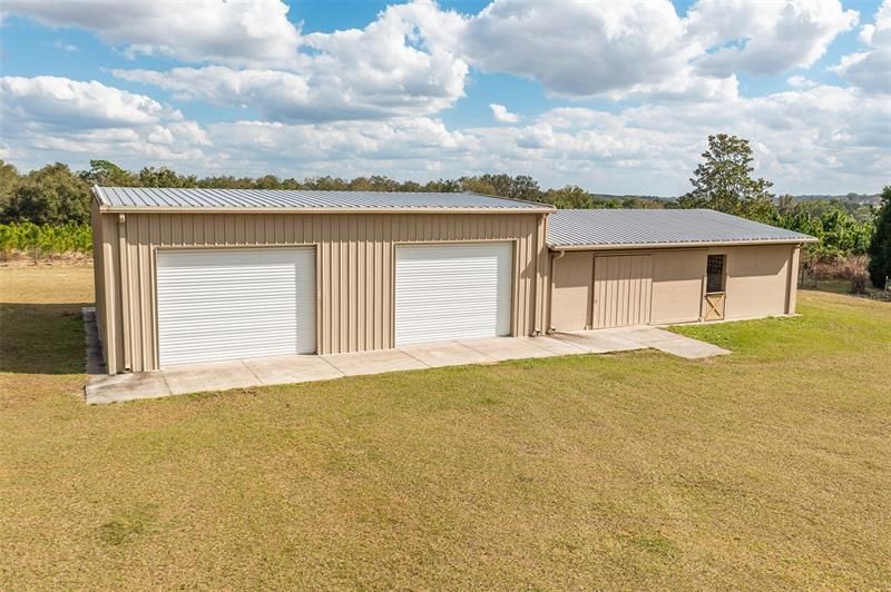 Almost 4,000 SF of total space in the RV/Boat Storage barn (left) and horse barn with stalls (right). The smaller structure on the right has concrete floors and ceiling. Electric and plumbing throughout the structure.