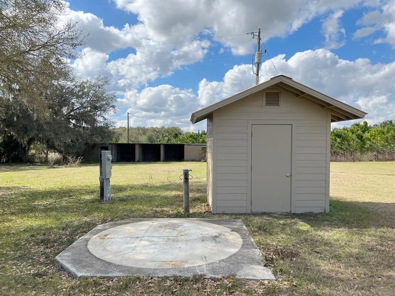 Utility shed and secondary storage structure in the background.