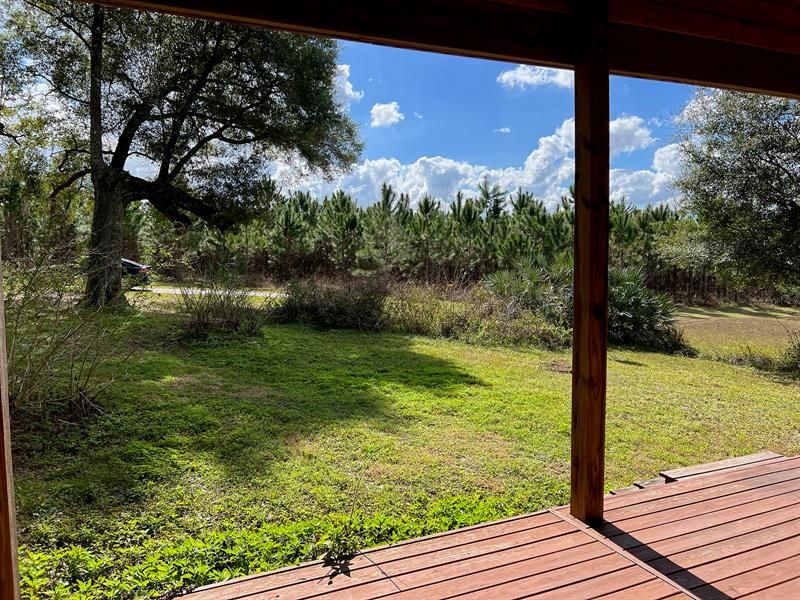 View from the front porch to the driveway and parking pad.