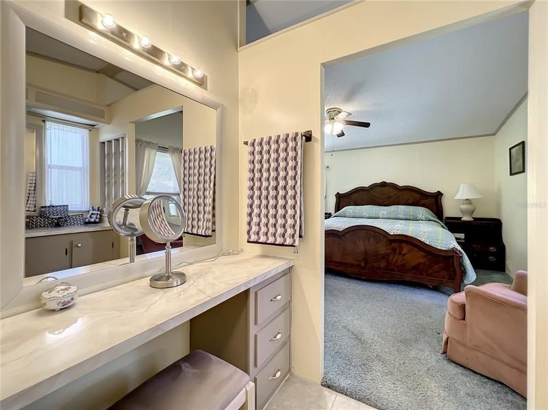 Make up vanity and view into the master bedroom
