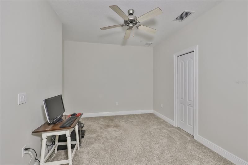 Office/den with French doors, closet, and ceiling fan