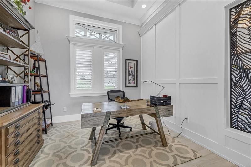 AT FRONT OF HOME TO RIGHT OF ENTRY IS YOUR HOME OFFICE THAT HOUSES A WALK IN CLOSET WITH CUSTOM CABINETS AND SHELVING, NEED EXTRA SLEEPING ROOM, ADD A PULL OUT OR FUTON OR WHAT HAVE YOU?