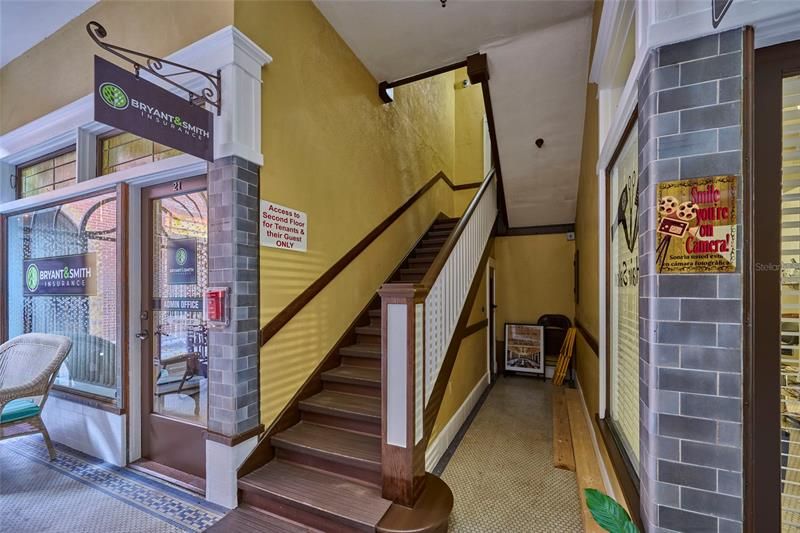Staircase to the second floor offers a storage room at the top
