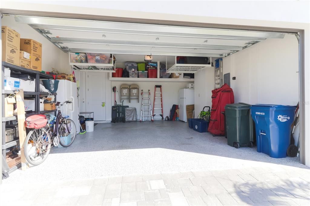 Garage has added storage racks and cabinets.