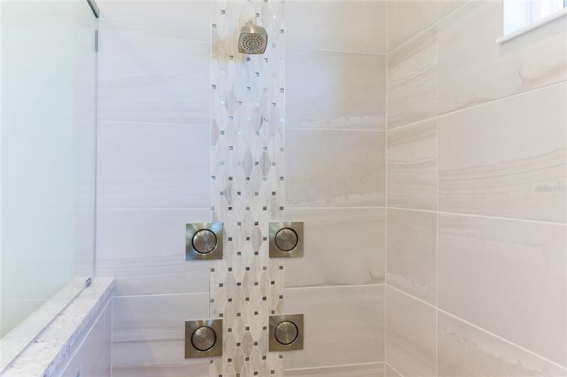 Primary shower with custom tile.