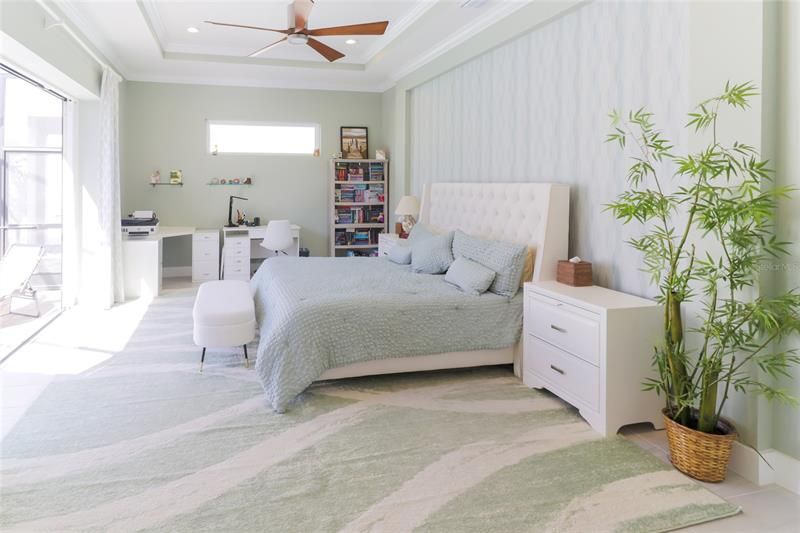 The primary bedroom is decorated with soft coastal hues.