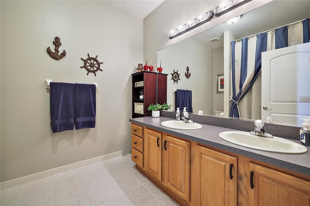 Bathroom Three with Dual Sinks and Tub/Shower Combo