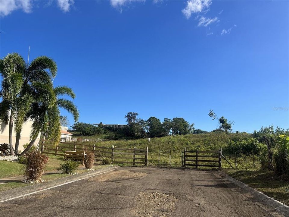 Main entrance, the land is at the end of the road on the right side