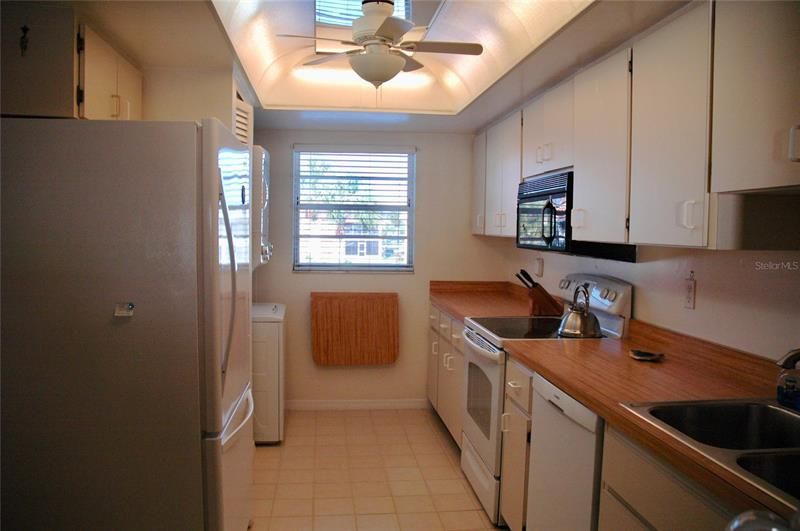 Kitchen with stackable clothes washer/dryer