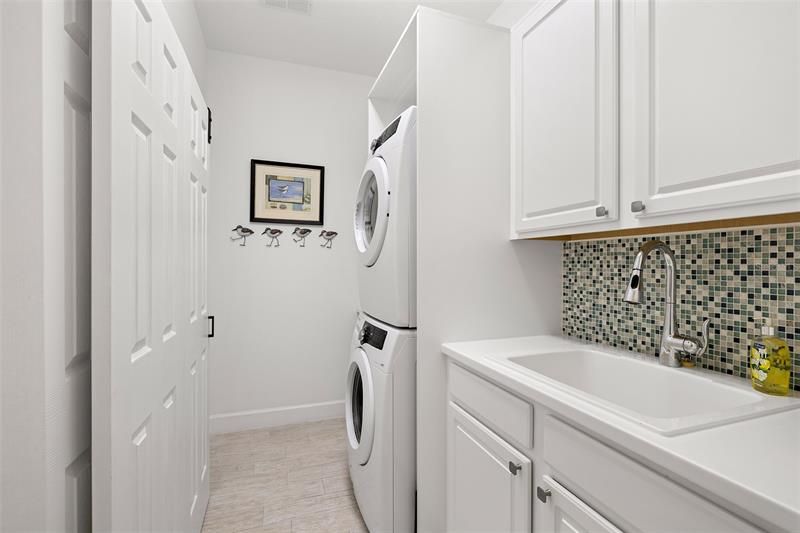 Laundry room with cabinets and sink.