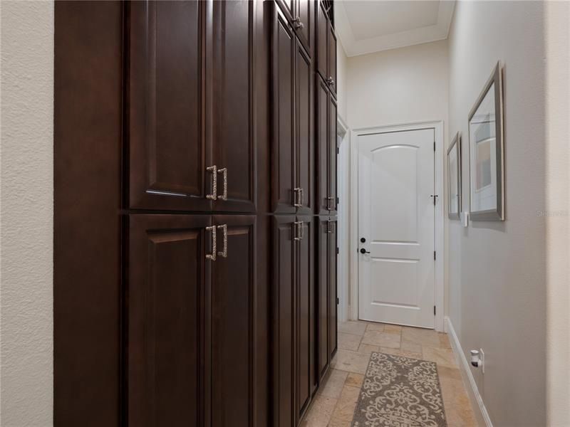 Pictured is a new custom floor-to-ceiling storage system in the mudroom hallway