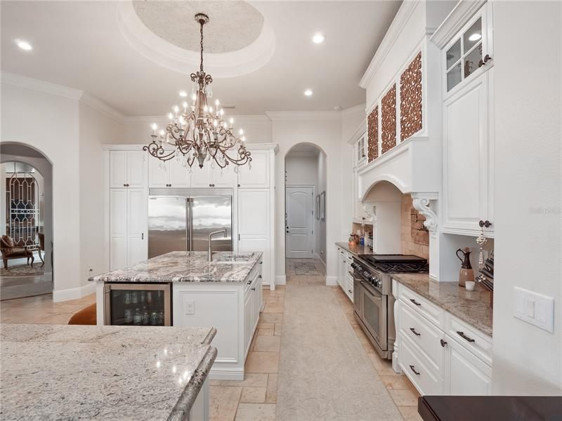 A huge floor-to-ceiling pantry abuts a chef’s dream kitchen that features a 6-burner gas stove, new island kitchen granite, hardware and fixtures, new instant hot/water chiller and disposal.