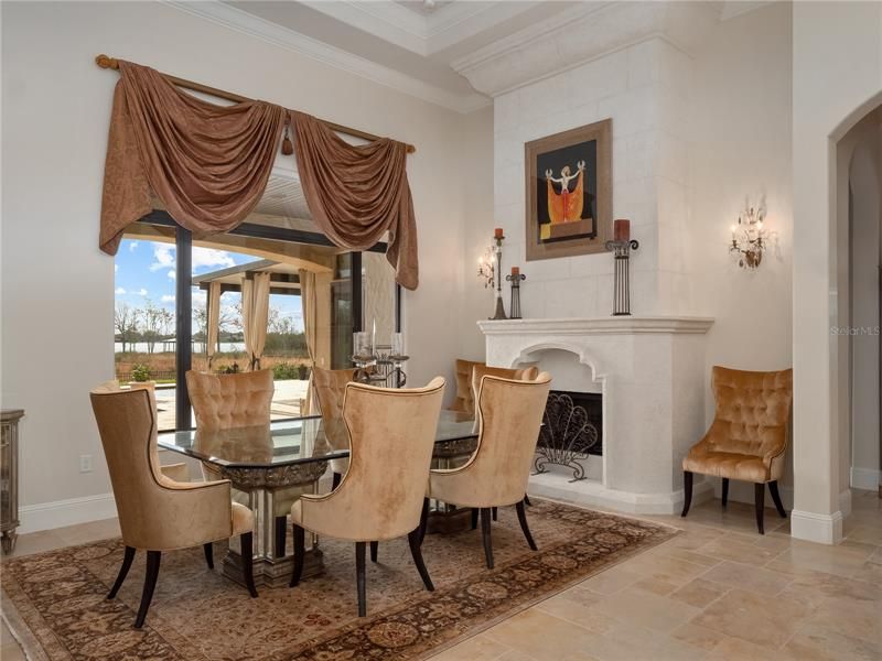 The living room and dining room spaces offer up amazing views of the lake. The dining room could also be used as the living room and features a gas fireplace and decorative ceiling accents.
