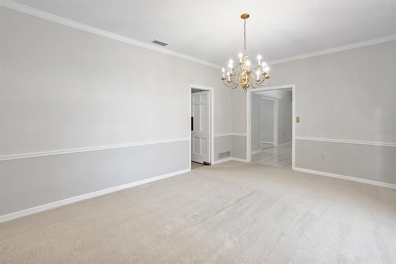 Dining room; swinging entry door to the kitchen to the left