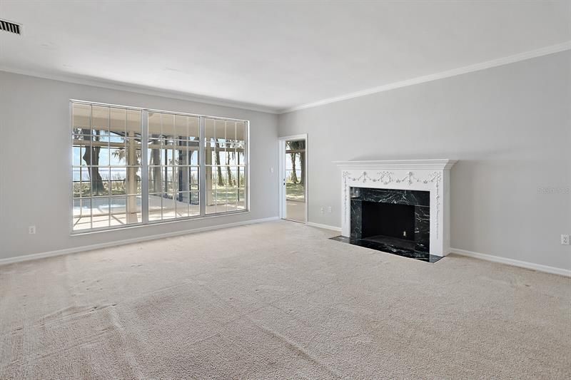 Formal living room with decorative fireplace and amazing Lake Eustis views