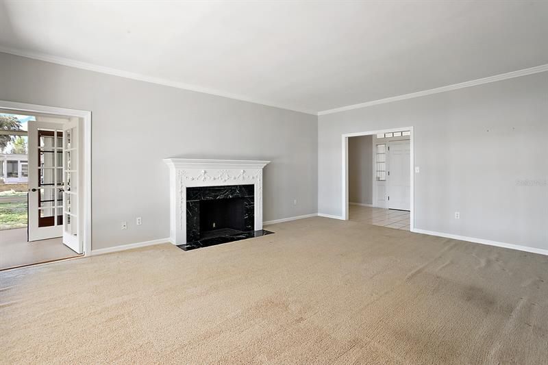 Formal living; foyer/entrance to the right; French door access (to the left) leads to the Florida room