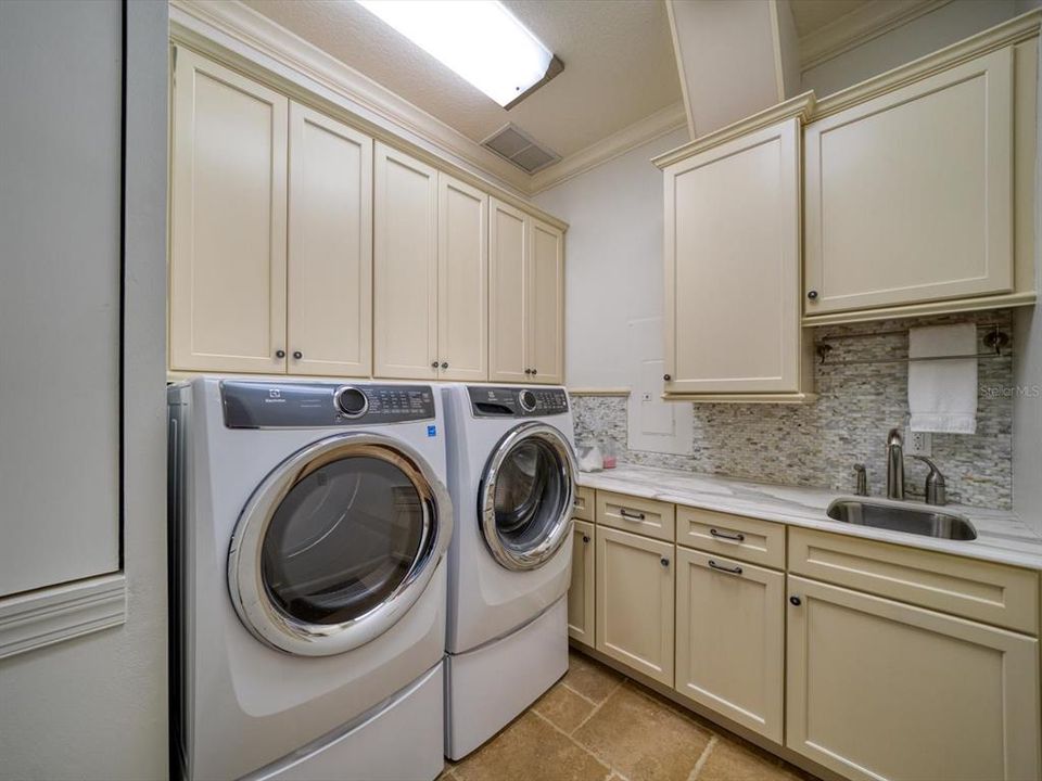 1st floor laundry, includes custom cabinets and laundry chute.