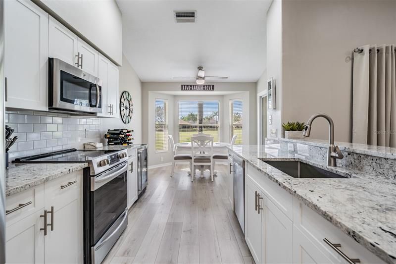All stainless appliances in the kitchen with breakfast nook view