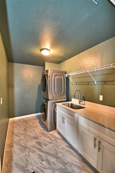 Laundry room with storage, folding space, and a soaking sink.