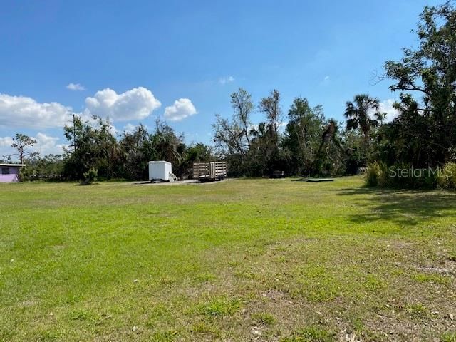 taaken from behind 4485 Blding showing side lot boundary w old concrete slab