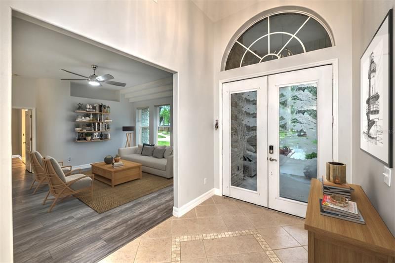 Tiled foyer with 12-foot ceiling and double-entry, etched doors.