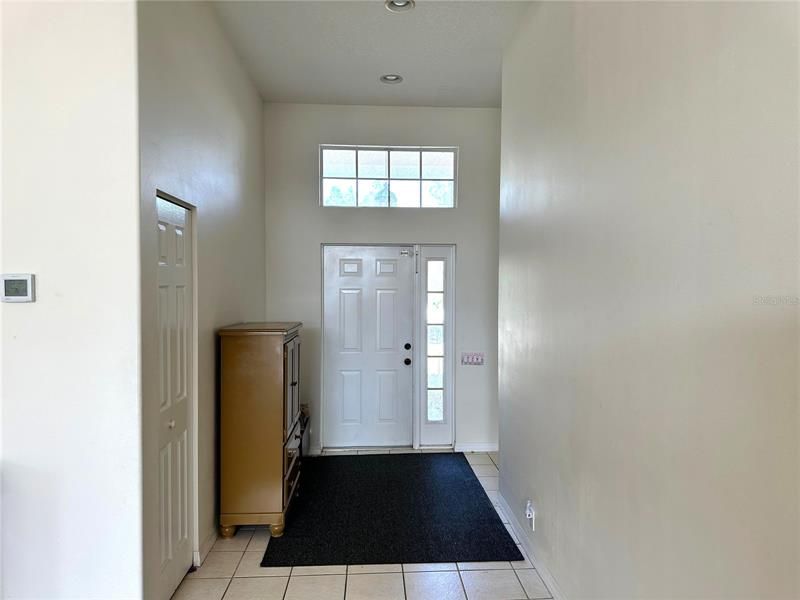 Front entrance with closet and tall ceilings