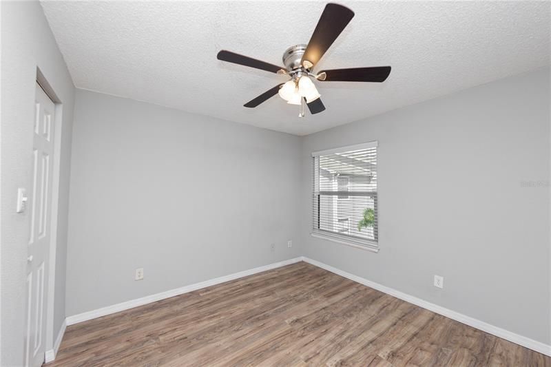 Large primary bedroom with ceiling fan