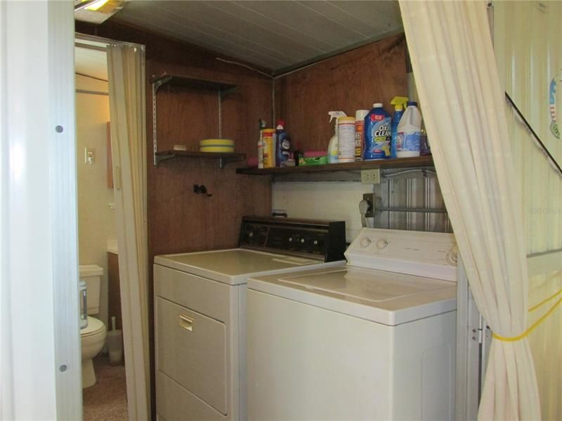 Inside laundry room comes with washer and dryer.