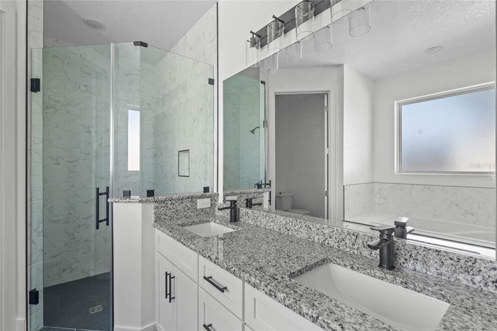 Master bath includes a double sink vanity and granite counters.