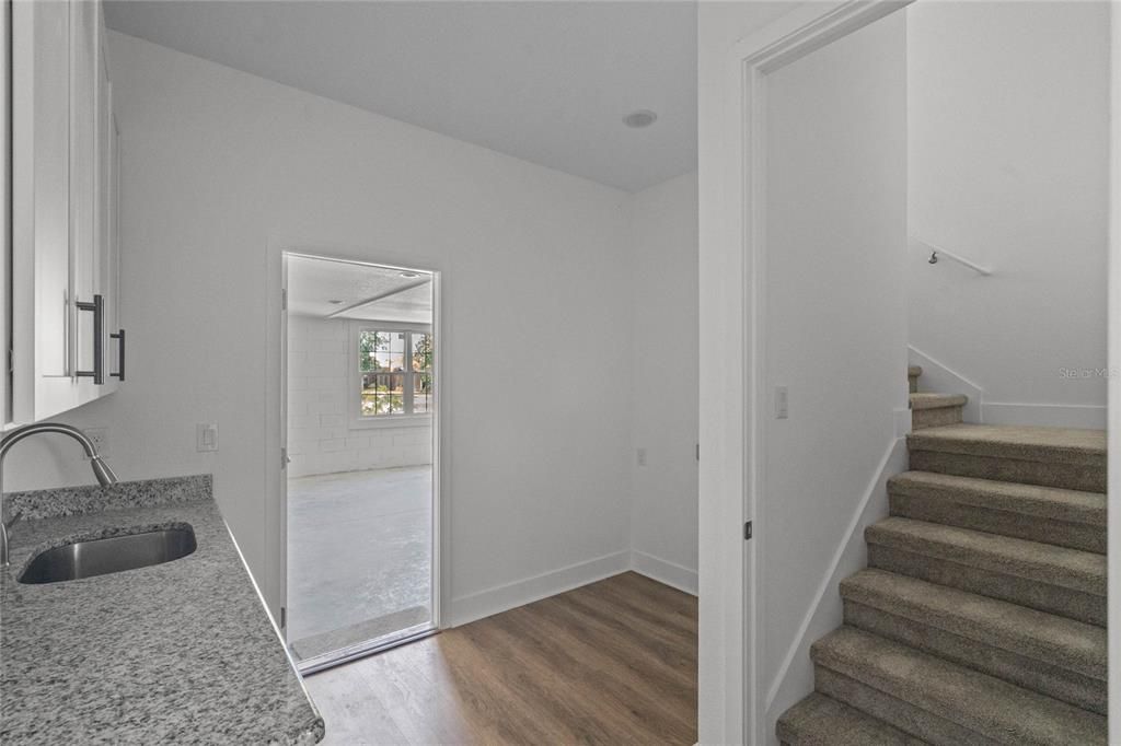 Enter through the garage to the laundry room and staircase up to the bonus room.