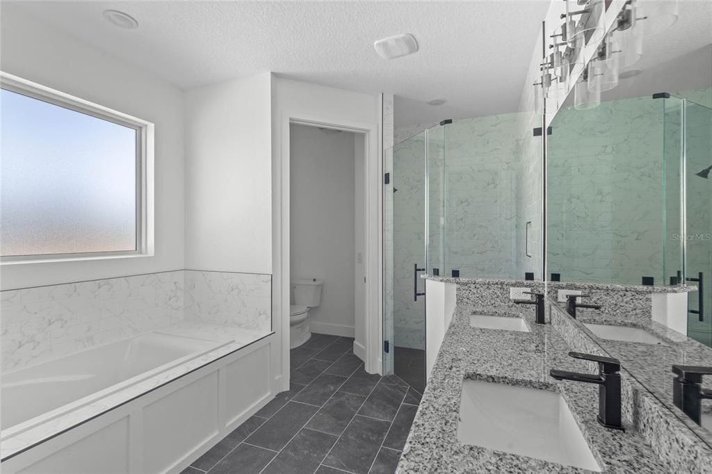 Master bathroom features a garden tub and large walk-in shower.