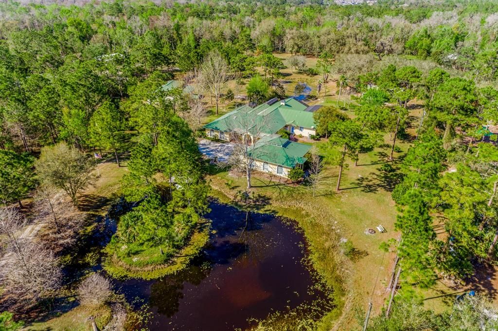 Space, privacy, beautiful bass stocked ponds and a gorgeous CUSTOM BUILT HOME with a GUEST/IN-LAW APARTMENT on OVER 5 ACRES in the heart of Oviedo, ZONED FOR A-RATED SCHOOLS - including Hagerty High!