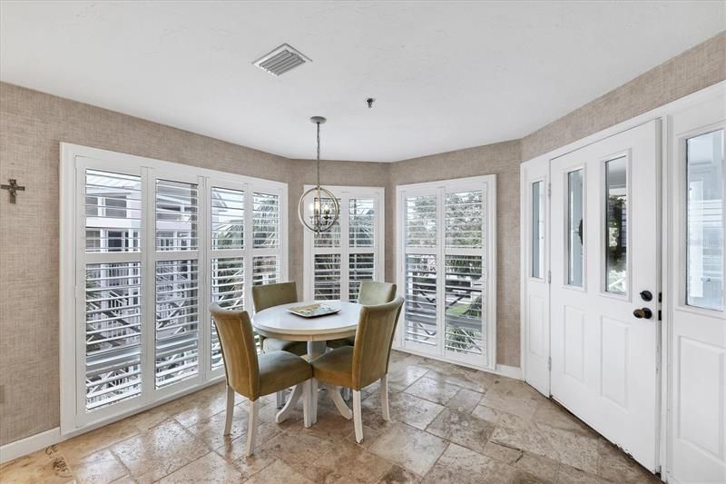 Sunroom/Breakfast Nook is adorned with plantation shutters