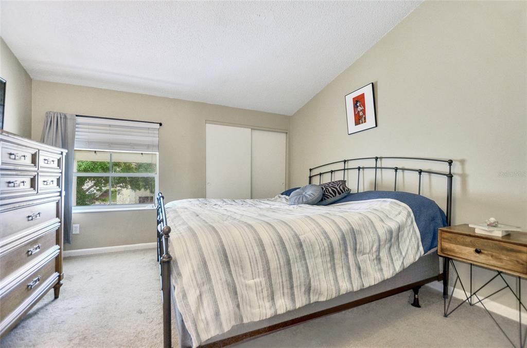 Primary bedroom offers plenty of space for a king sized bed and dressers.