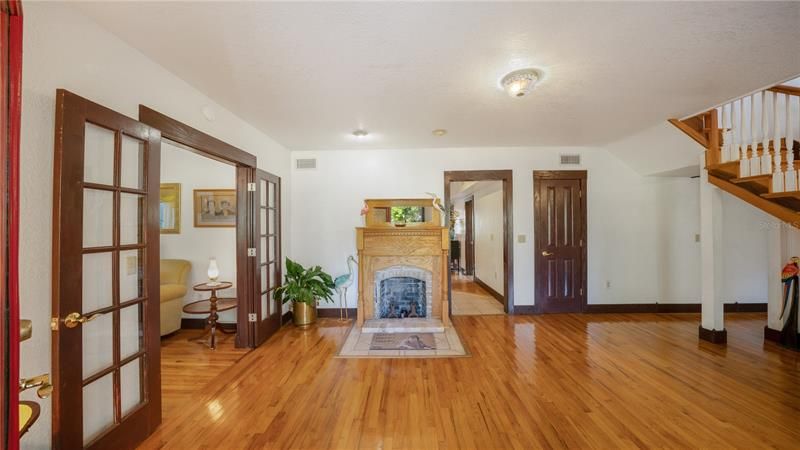 Foyer (Entry way into the home. Original hardwood floors and double-sided fireplace
